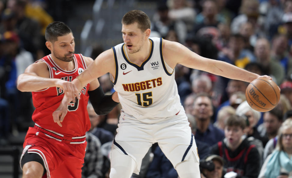 Denver Nuggets center Nikola Jokic, right, tries to drives to the rim as Chicago Bulls center Nikola Vucevic defends in the second half of an NBA basketball game Wednesday, March 8, 2023, in Denver. (AP Photo/David Zalubowski)