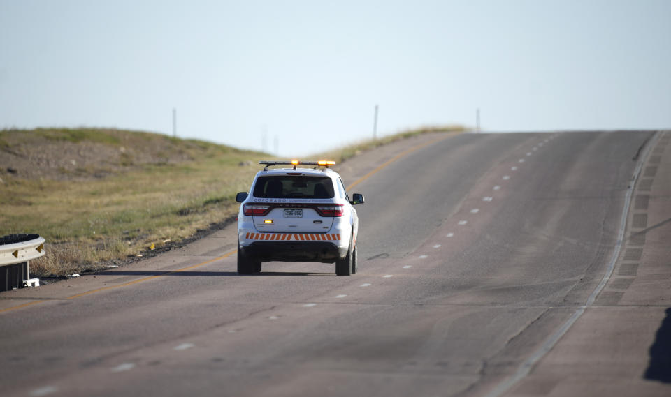 A vehicle from the Colorado Department of Transportation moves southbound on an empty Interstate 25 closed by a rail accident, Monday, Oct. 16, 2023, north of Pueblo, Colo. (AP Photo/David Zalubowski)