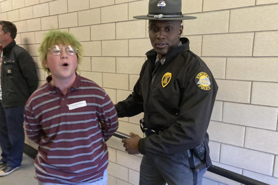 A protester is led away after police made arrests at the Kentucky Capitol. Wednesday, March 29, 2023, in Frankfort, Ky. Arrests were made as state lawmakers completed an override of a veto of a transgender bill regulating some of the most personal aspects of life for transgender young people — from banning access to gender-affirming health care to restricting the bathrooms they can use. (AP Photo/Bruce Schreiner)