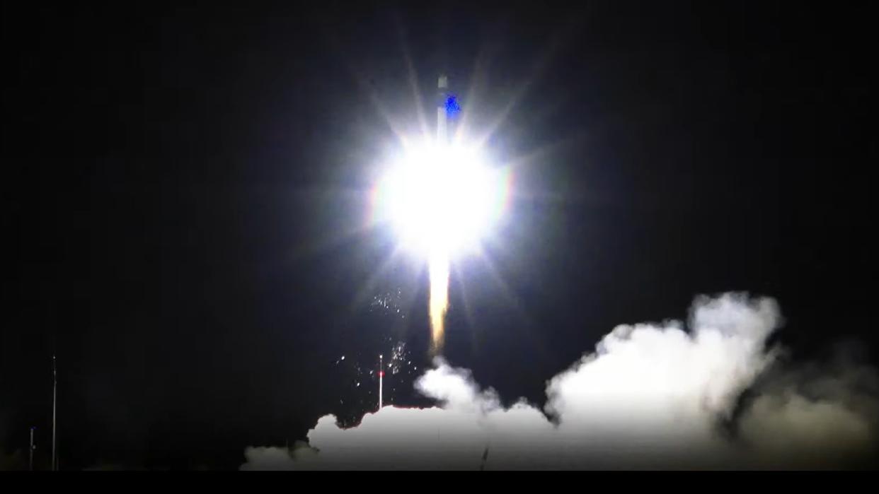  A rocket lifting off into the darkness. 