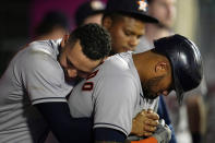 Houston Astros' Martin Maldonado, right, is hugged by Carlos Correa after Maldonado's solo home run during the sixth inning of a baseball game against the Los Angeles Angels Tuesday, Sept. 21, 2021, in Anaheim, Calif. (AP Photo/Marcio Jose Sanchez)