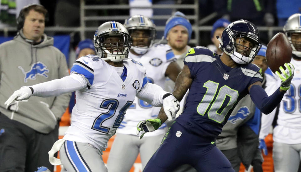 Seattle Seahawks wide receiver Paul Richardson (10) makes a one-handed catch ahead of Detroit Lions cornerback Nevin Lawson, left, in the second half of an NFL football NFC wild card playoff game, Saturday, Jan. 7, 2017, in Seattle. (AP Photo/Elaine Thompson)