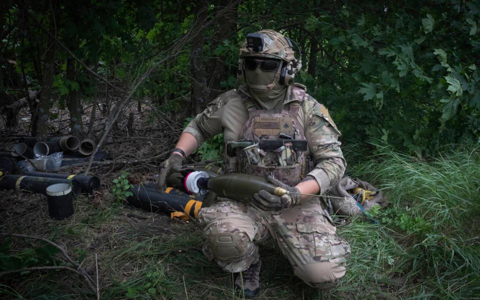 A Ukrainian soldier prepares ammunition to fire towards Russian positions on the frontline in the Zaporizhzhia region