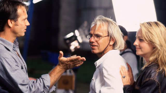 <p>Warner Bros.</p> Bill Paxton, Jan de Bont, and Helen Hunt filming 'Twister.'