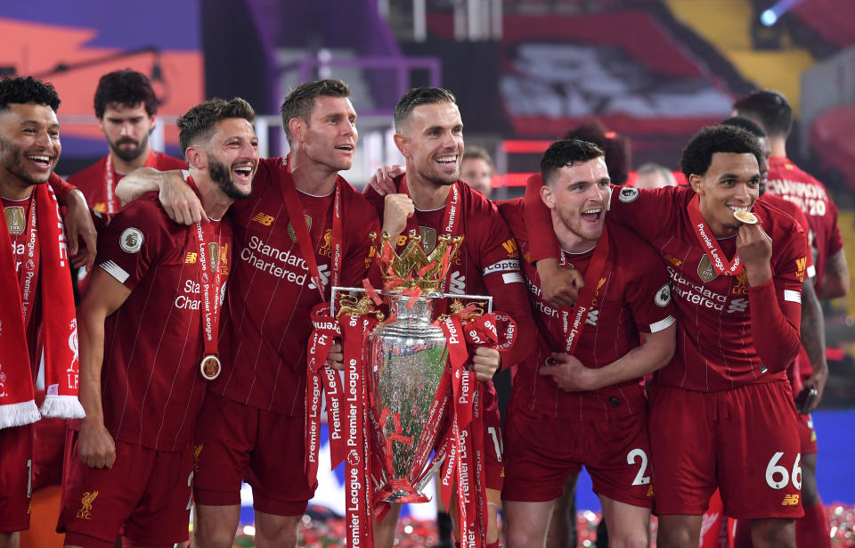 Left to right, Liverpool's Alex Oxlade-Chamberlain, Adam Lallana, James Milner, Jordan Henderson, Andrew Robertson and Trent Alexander-Arnold celebrate with the Premier League trophy after the Premier League match at Anfield, Liverpool. (Photo by Laurence Griffiths/PA Images via Getty Images)