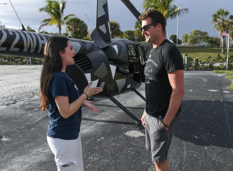 Ava Shelly, 16, of Port St. Lucie, talks with her instructor Christian Clark, of Treasure Coast Helicopters, before she prepares to fly his Robinson R44 helicopter at the his launch/landing field at the Causeway Cove Marina in Fort pierce on Thursday, Feb. 8, 2024. Shelly received her pilot's license for helicopters, along with Flying gliders, and airplanes all on her 16th birthday on Jan 21.
