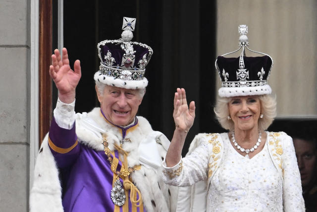 Britain&#39;s King Charles III wearing the Imperial state Crown, and Britain&#39;s Queen Camilla wearing a modified version of Queen Mary&#39;s Crown wave from the Buckingham Palace balcony after viewing the Royal Air Force fly-past in central London on May 6, 2023, after their coronations. - The set-piece coronation is the first in Britain in 70 years, and only the second in history to be televised. Charles will be the 40th reigning monarch to be crowned at the central London church since King William I in 1066. (Photo by Marco BERTORELLO / AFP) (Photo by MARCO BERTORELLO/AFP via Getty Images)