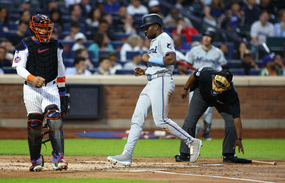 Miami Marlins outfielder Jesús Sánchez (12) scores against the New York Mets during the second inning of a baseball game, Tuesday, June 11, 2024, in New York. (AP Photo/Noah K. Murray)