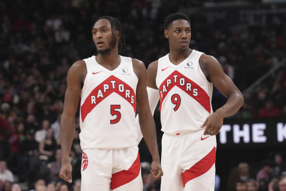 Toronto Raptors newly acquired pair Immanuel Quickley (5) and RJ Barrett (9) look on the during the first half of an NBA basketball game in Toronto, Monday, Jan. 1, 2024. (Chris Young/The Canadian Press via AP)