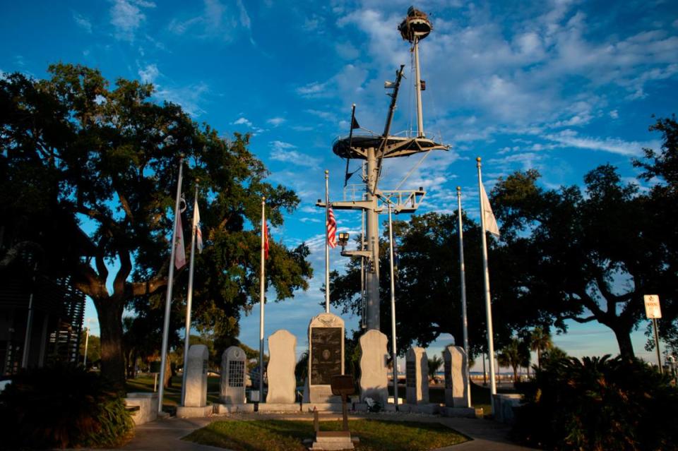 The mast of the U.S.S. Biloxi, which is now part of its memorial, sits behind the WWII memorial at Guice Park in Biloxi on Monday, Nov. 27, 2023. Hannah Ruhoff/Sun Herald