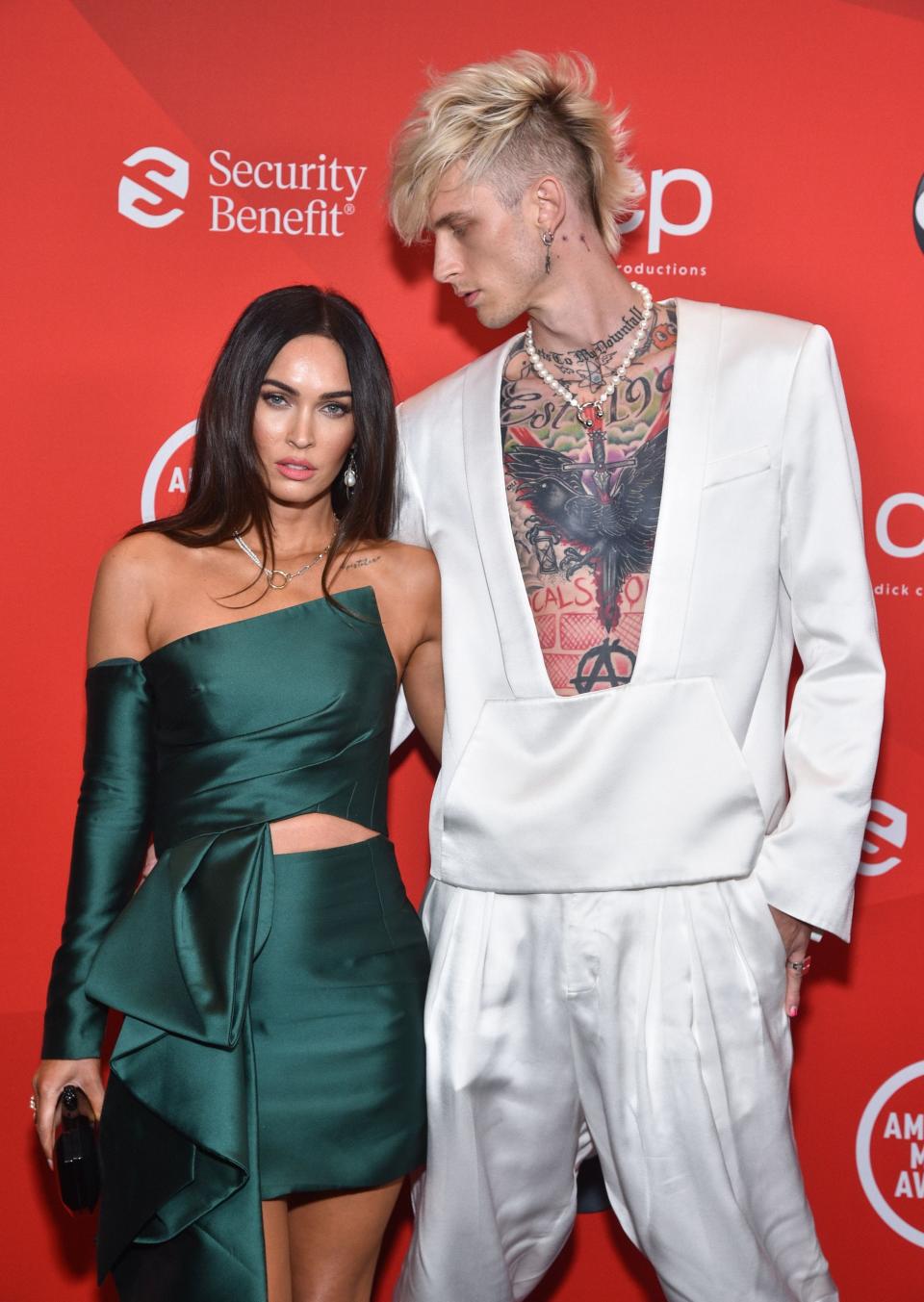 Megan Fox, left, and boyfriend Machine Gun Kelly arrive at Sunday's AMAs.