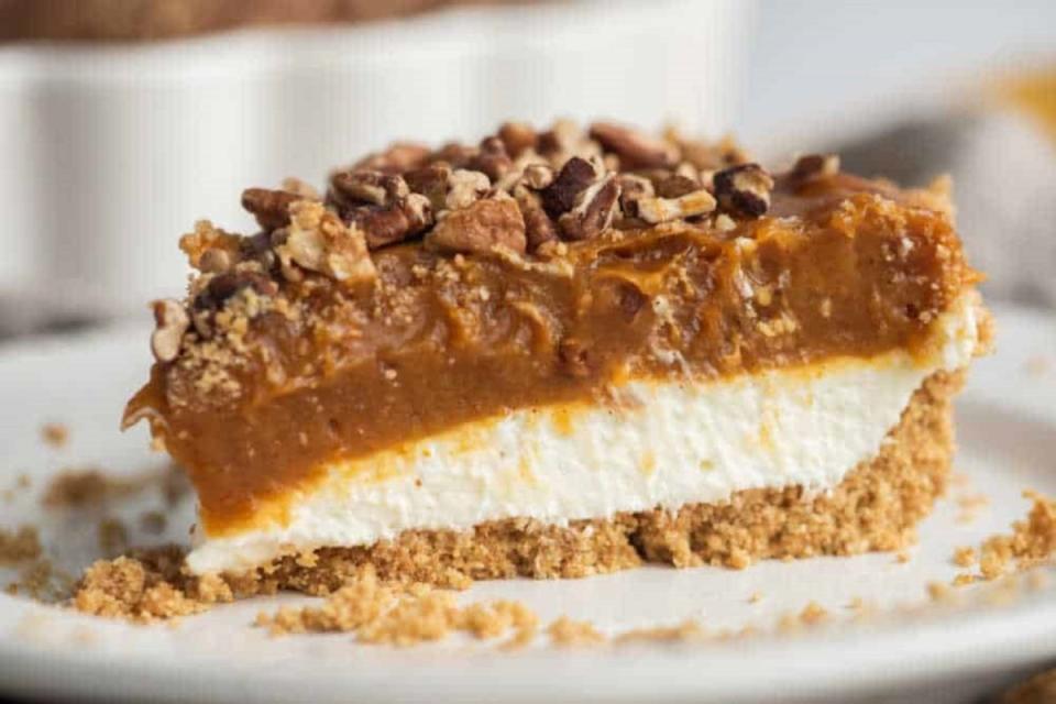 <p>This easy no-bake layered holiday dessert is two desserts in one: pumpkin pie AND cheesecake! </p><p><strong>Get the recipe: </strong><a href="https://www.simplystacie.net/pumpkin-pie-cheesecake/" rel="nofollow noopener" target="_blank" data-ylk="slk:Pumpkin Pie Cheesecake;elm:context_link;itc:0;sec:content-canvas" class="link "><strong>Pumpkin Pie Cheesecake</strong></a></p>