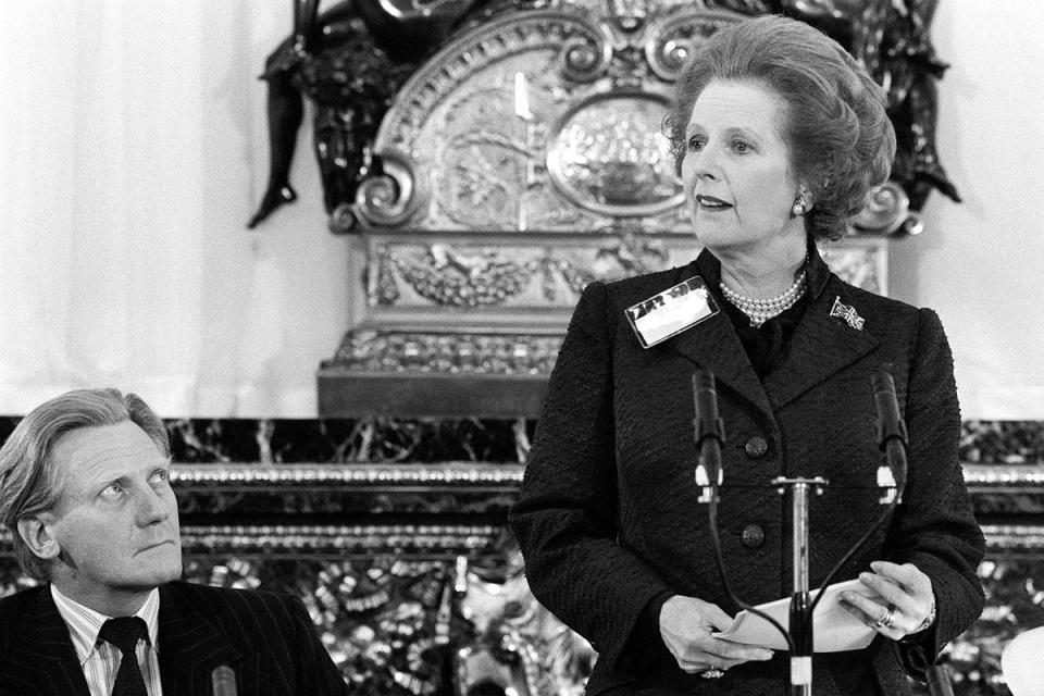 Prime Minister Margaret Thatcher, watched closely by Defence Secretary Michael Heseltine (left), during her speech at the opening of an all-day seminar on Science and Technology, which the Premier chaired at Lancaster House, in London, 1983. (PA)