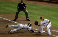 ARLINGTON, TX - OCTOBER 23: Nick Punto #8 of the St. Louis Cardinals dives safely back to first base before the tag by Mitch Moreland #18 of the Texas Rangers in the sixth inning during Game Four of the MLB World Series at Rangers Ballpark in Arlington on October 23, 2011 in Arlington, Texas. (Photo by Rob Carr/Getty Images)