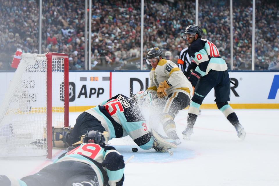 Jan 1, 2024; Seattle, Washington, USA; Seattle Kraken goaltender Joey Daccord (35) blocks a goal shot by Vegas Golden Knights right wing Jonathan Marchessault (81) during the first period in the 2024 Winter Classic ice hockey game at T-Mobile Park. Mandatory Credit: Steven Bisig-USA TODAY Sports