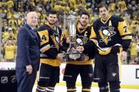 May 26, 2016; Pittsburgh, PA, USA; NHL deputy commissioner Bill Daly (L) presents the Prince of Wales trophy to Pittsburgh Penguins left wing Chris Kunitz (14), center Sidney Crosby (C), and center Evgeni Malkin (71) after defeating the Tampa Bay Lightning 2-1 to win the Eastern Conference Championship in game seven of the Eastern Conference Final of the 2016 Stanley Cup Playoffs at the CONSOL Energy Center. Mandatory Credit: Charles LeClaire-USA TODAY Sports