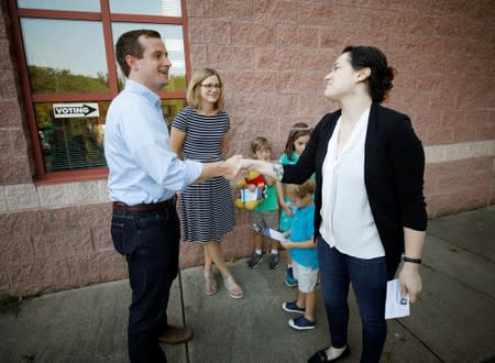 Dan McCready, Democratic candidate in the special election for North Carolina's 9th Congressional District, shakes hands with a voter outside a polling station in Charlotte, North Carolina