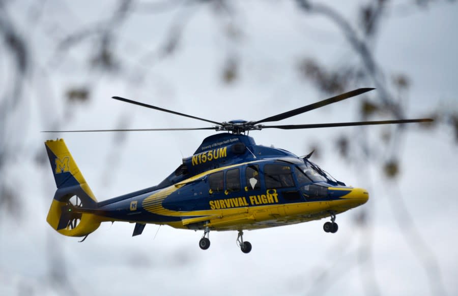 A University of Michigan Health Systems Survival Flight responds to the Swan Creek Boat Club after a driver crashed a vehicle through a building where a children’s birthday party was taking place, Saturday, April 20, 2024, in Berlin Township, Mich. (Kathleen Kildee/Detroit News via AP)