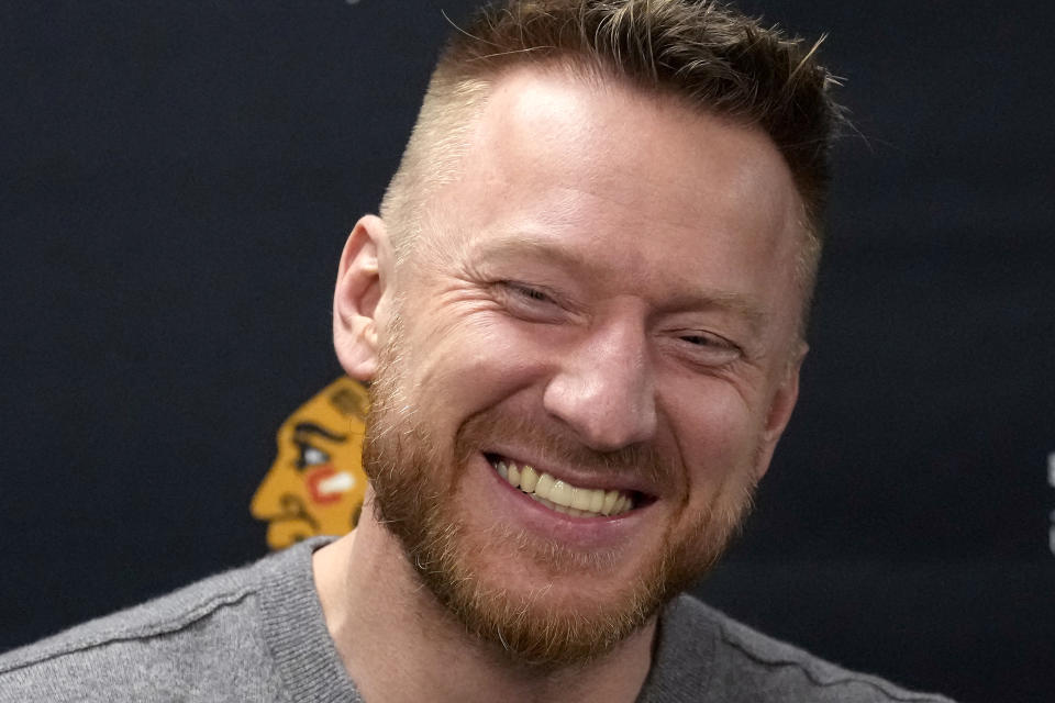 Former Chicago Blackhawks great Marian Hossa smiles as he talks with reporters before an NHL hockey game between the Blackhawks and the St. Louis Blues Wednesday, Nov. 16, 2022, in Chicago. The Blackhawks are planning to retire Hossa's No. 81 sweater before Sunday's game against the Pittsburgh Penguins. (AP Photo/Charles Rex Arbogast)