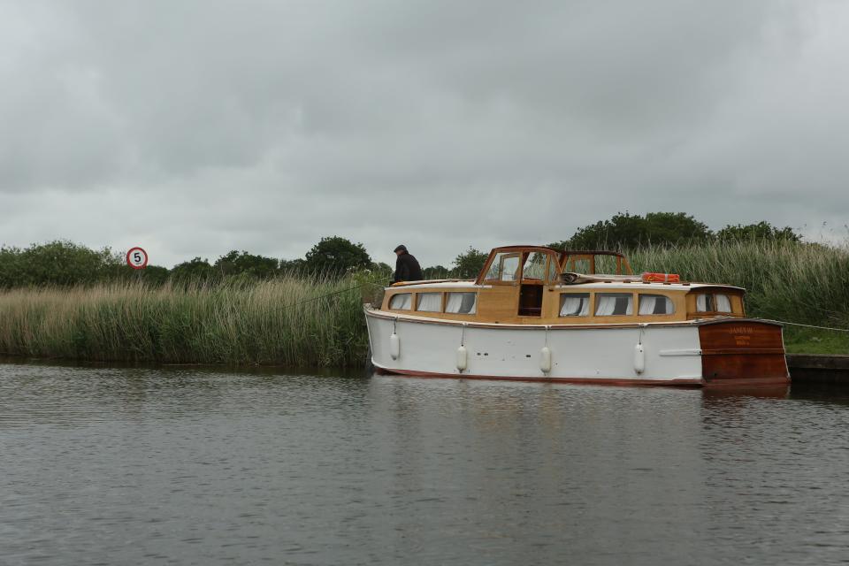 An angler fishes from the bank close to Hickling Broad, Norfolk. Picture date: Saturday June 19, 2021. Photographer: Johnny Green