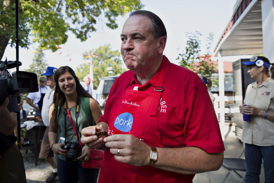 Former Arkansas Gov. Mike Huckabee (R) samples a pork chop.