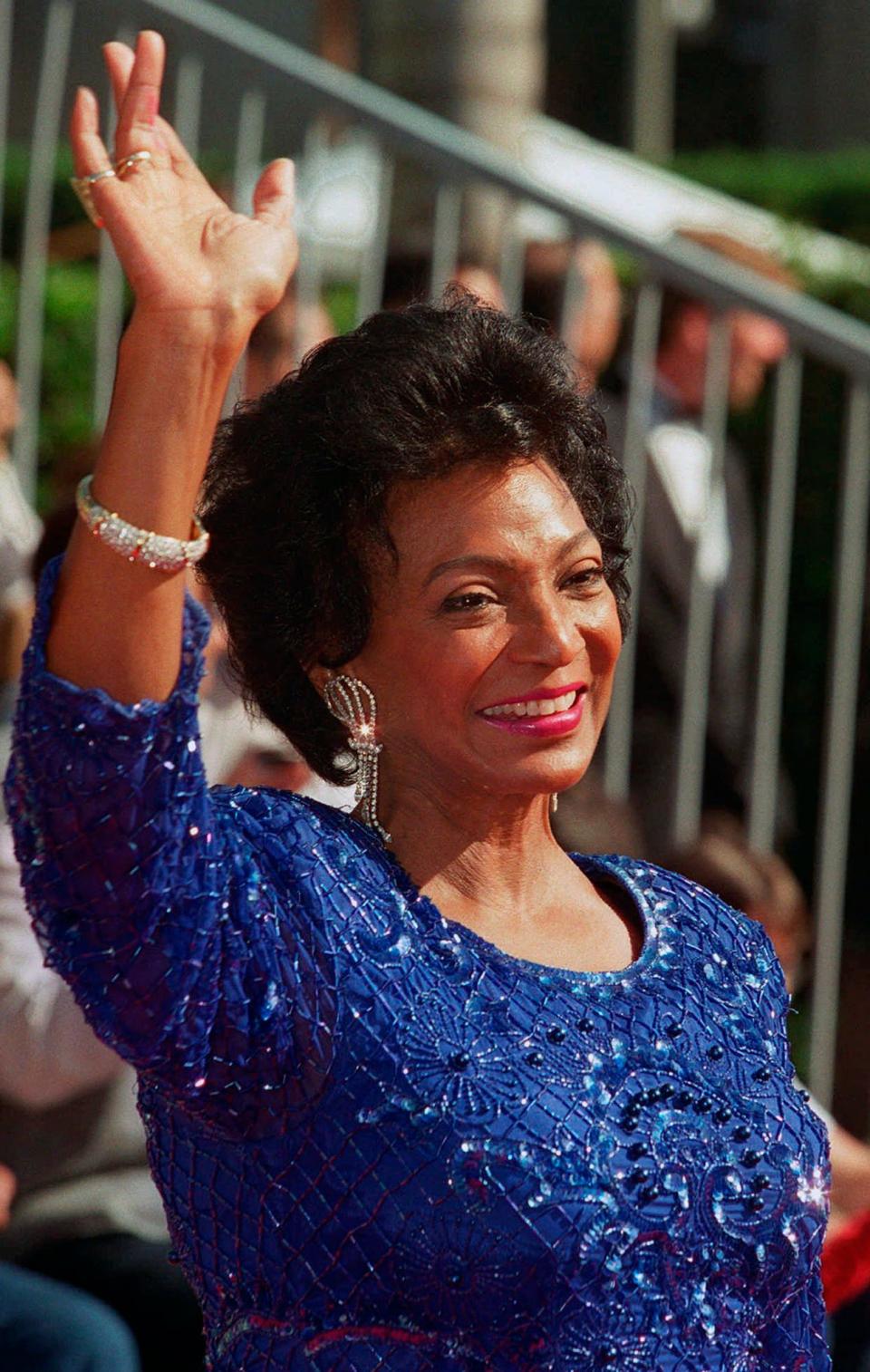 FILE - Actor Nichelle Nichols, who played Lt. Ntoya Uhura on ''Star Trek,'' waves as she arrives at the "Star Trek: 30 Years and Beyond" tribute at Paramount Studios in Los Angeles, Sunday, Oct. 6, 1996. Nichols died Saturday, July 30, 2022, her family said. She was 89. (AP Photo/Damian Dovarganes, File)