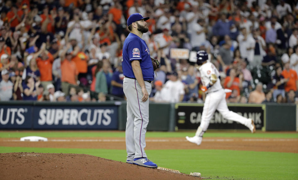 Texas Rangers starting pitcher Lance Lynn, left, looks toward the outfield as Houston Astros Yuli Gurriel runs the bases after hitting a home run during the fifth inning of a baseball game Tuesday, Sept. 17, 2019, in Houston. (AP Photo/David J. Phillip)