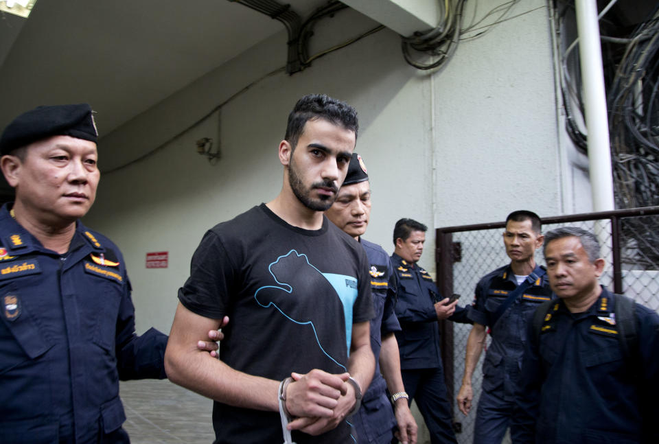 Thai prison guards lead Bahraini football player Hakeem al-Araibi, second left, from a court house in Bangkok, Thailand, Tuesday, Dec. 11, 2018. A Thai court has ruled that the soccer player who holds refugee status in Australia can be held for 60 days pending the completion of an extradition request by Bahrain, the homeland he fled four years ago on account of alleged political persecution. (AP Photo/Gemunu Amarasinghe)