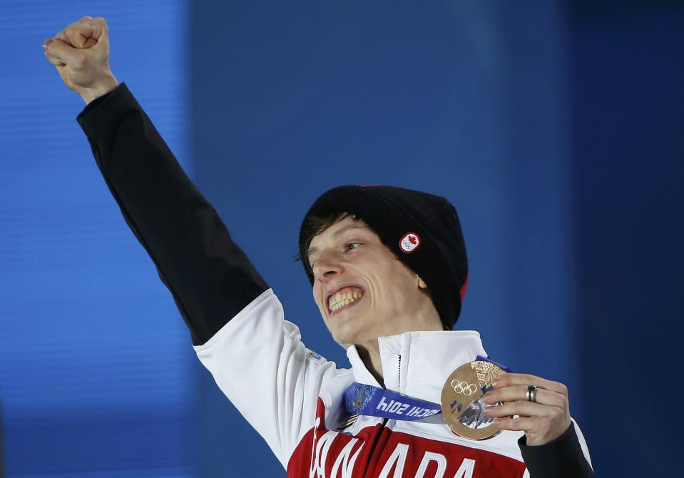 Bronze medallist Canada's Charle Cournoyer celebrates during the victory ceremony for the men's 500 metres short track speed skating event at the 2014 Sochi Winter Olympics in Sochi