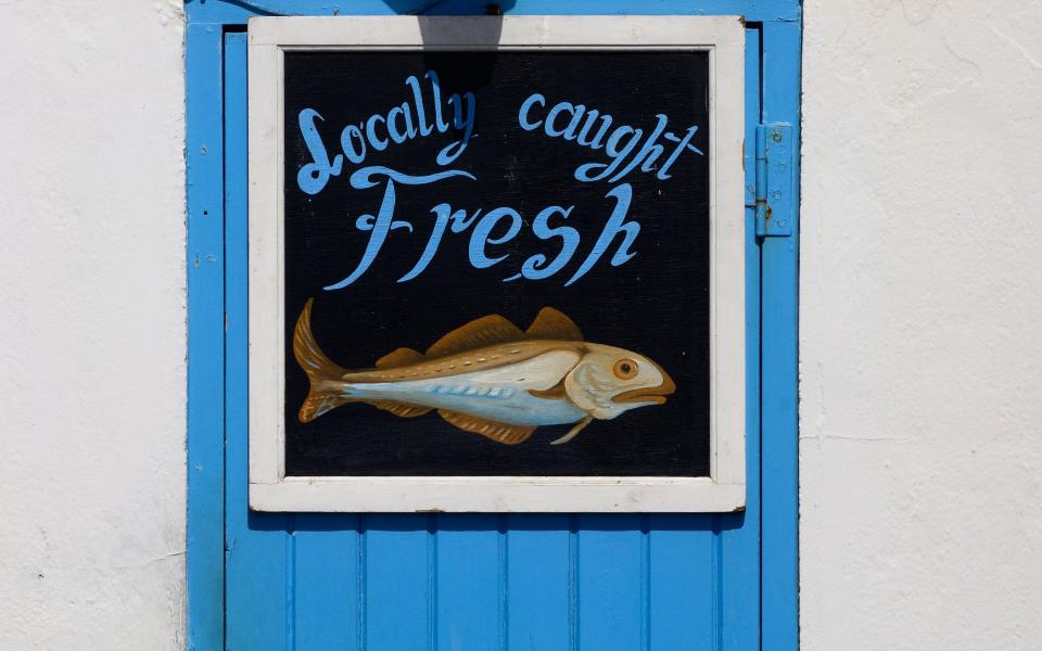 Hand painted sea fish shop sign. Hastings. East Sussex. UK