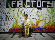 Blind Japanese skateboarder Ryusei Ouchi poses for a photograph holding a cane at a skatepark in Tokorozawa, north of Tokyo