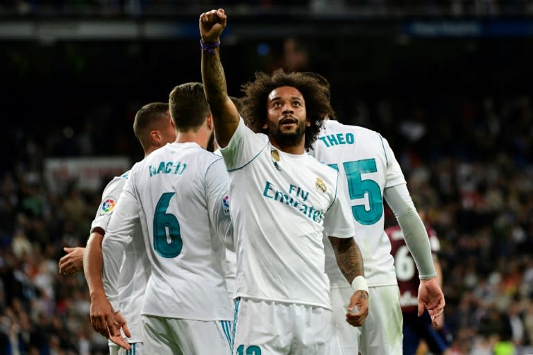 Real Madrid's Brazilian defender Marcelo celebrates after scoring his team's third goal during the Spanish league football match against Eibar at the Santiago Bernabeu stadium in Madrid on October 22, 2017