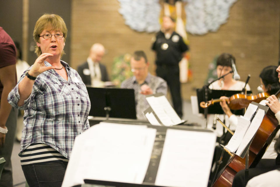 Music in Prisons Artistic Director Sara Lee leads a group of Chicago Symphony Orchestra musicians and inmates at the Cook County Juvenile Detention Center in a performance for friends and families of inmates, Sunday, April 14, 2013. (AP Photo/Todd Rosenberg)