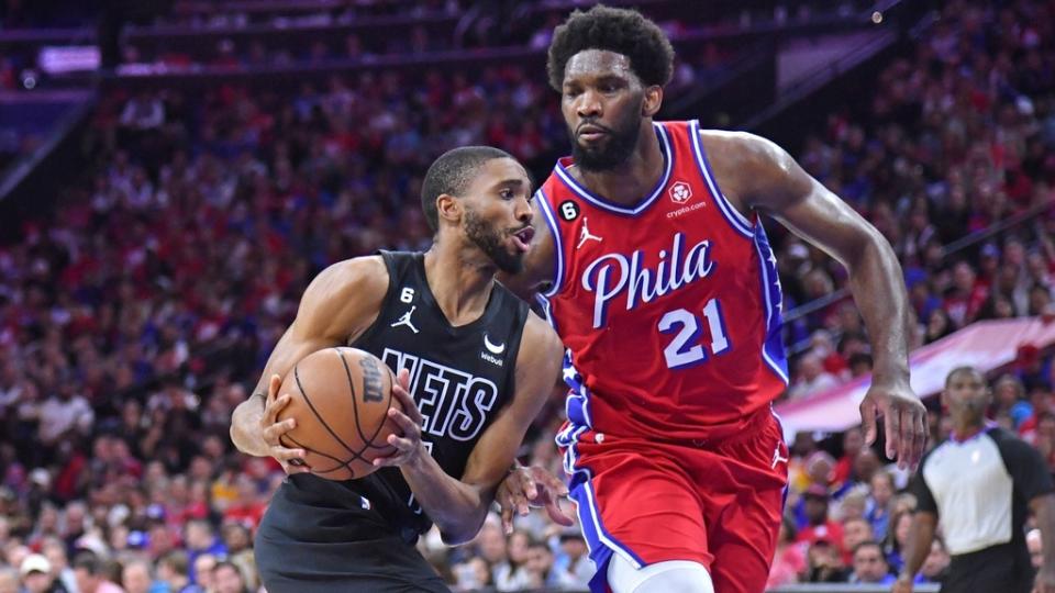 Apr 15, 2023; Philadelphia, Pennsylvania, USA; Brooklyn Nets forward Mikal Bridges (1) drives to the basket against Philadelphia 76ers center Joel Embiid (21) during the second quarter of game one of the 2023 NBA playoffs at Wells Fargo Center.