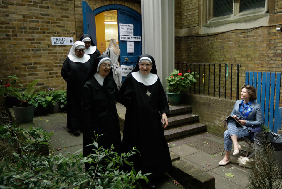 Benedictine nuns leave a polling station after voting