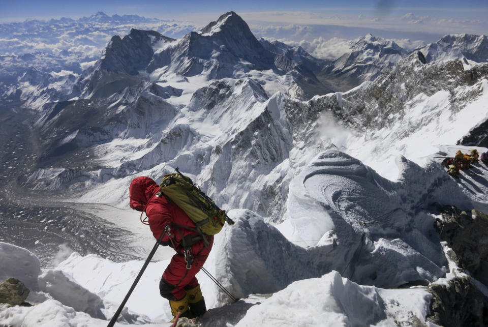FILE - In this May 18, 2013 file photo released by Alpenglow Expeditions, a climber prepares to descend the Hillary Step as he makes his way down from the summit of Mount Everest, in the Khumbu region of the Nepal Himalayas. Nepal will slash the climbing fees for Mount Everest to attract more mountaineers to the world's highest peak, even as concerns grow about the environmental effects of thousands of climbers who already crowd the mountain during the high season. Madhusudan Burlakoti, head of Nepal's Department of Mountains, said Friday, Feb. 14, 2014 that beginning next year, it will cost $11,000 per climber to climb Everest. (AP Photo/Alpenglow Expeditions, Adrian Ballinger, File) MANDATORY CREDIT, EDITORIAL USE ONLY