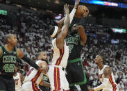Boston Celtics guard Jaylen Brown (7) drives to the basket as Miami Heat center Bam Adebayo, center left, defends during the first half of Game 4 of an NBA basketball first-round playoff series Monday, April 29, 2024, in Miami. (AP Photo/Marta Lavandier)
