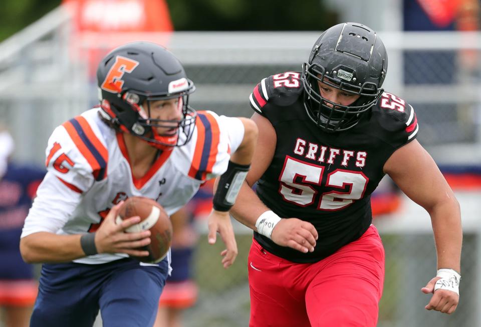 Buchtel's Davian Greenlee chases down Ellet quarterback Jake Flossie during the second half of a high school football game, Saturday, Sept. 24, 2022, in Akron, Ohio.