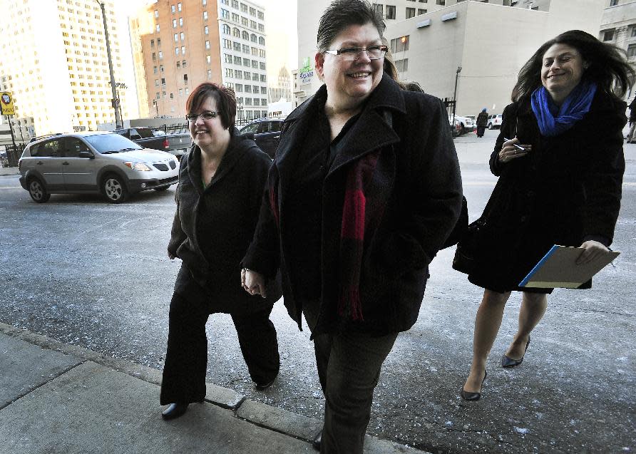 From left, April DeBoer and Jayne Rowse with DeBoer's attorney Dana Nessel enter Federal Court in Detroit, Tuesday, Feb. 25, 2014 before a trial that could overturn Michigan's ban on gay marriage. Gay couples poised for a favorable ruling last fall had lined up for licenses at county offices across Michigan, only to be stunned when U.S. District Judge Bernard Friedman said he wanted to hear testimony from experts. The case began in 2012 when nurses Rowse, 49, and DeBoer, 42, of Hazel Park sued to try to upset a Michigan law that bars them from adopting each other's children. But the case became even more significant when Friedman invited them to add the same-sex marriage ban to their lawsuit. They argue that Michigan's constitutional amendment, approved by voters in 2004, violates the U.S. Constitution's Equal Protection Clause, which forbids states from treating people differently under the law. (AP Photo/Detroit News, Daniel Mears) DETROIT FREE PRESS OUT; HUFFINGTON POST OUT