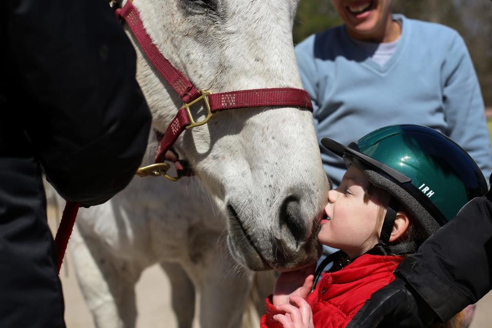 After her lesson, Kady, -then-4, gives her horse a kiss in March 2016 at Prancing Horse Therapeutic Riding Center. Prancing Horse is a nonprofit organization for special needs children and adults in the Sandhills area.