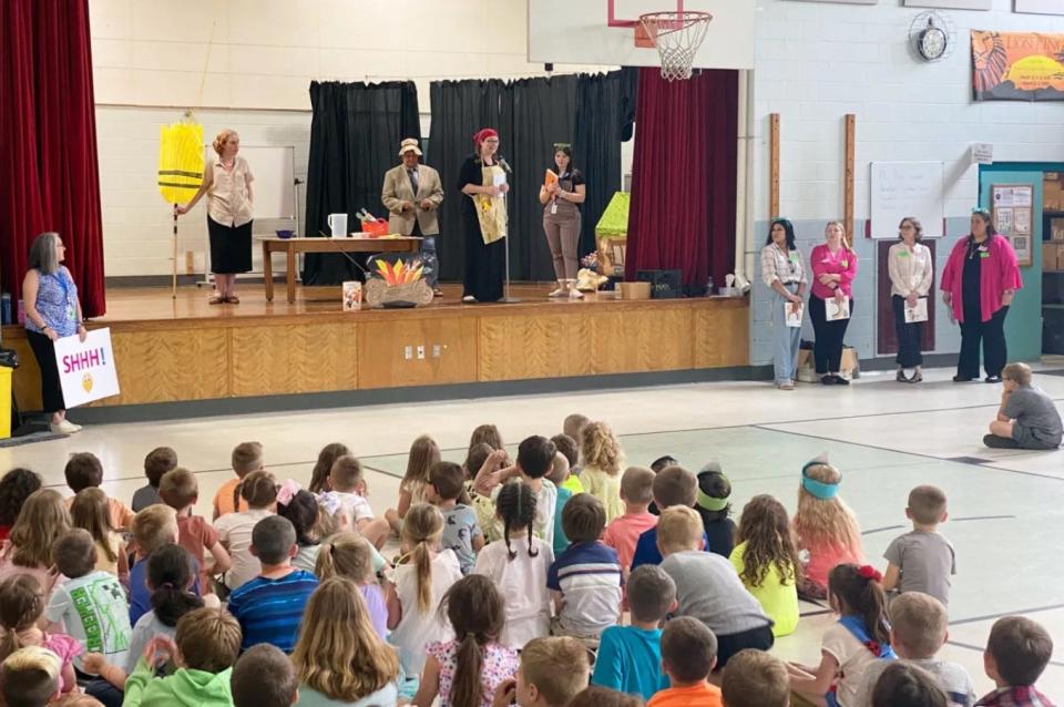 Reading teachers at the East Rochester School present a skit to students to help kickoff a summer reading program.