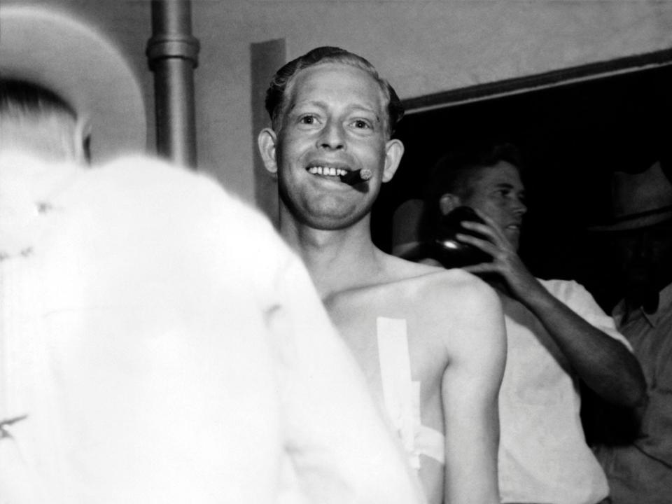 Jack Sullivan who murdered John Bradbury, a railroad officer, during a gun fight, is seen smoking a cigar a few moments before he took his last breath in the lethal gas execution chamber at the state prison on May 17, 1936 in Florence, Arizona.