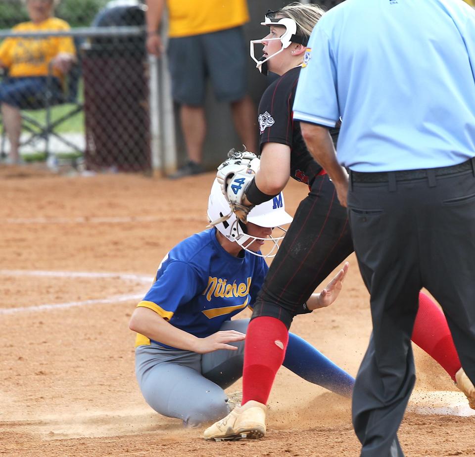Mitchell's Emma Chastain (57) slides into second as the Orleans player waits for the late throw on Tuesday, April 30, 2024. Chastain was safe on the play.