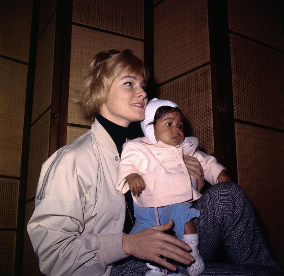 <p>May cradles her four-month-old daughter, Tracey Davis, while arriving in Stockholm, Sweden, for a visit with her parents in 1961. It was the first time the actress's parents met her child with singer Sammy Davis, Jr.</p>