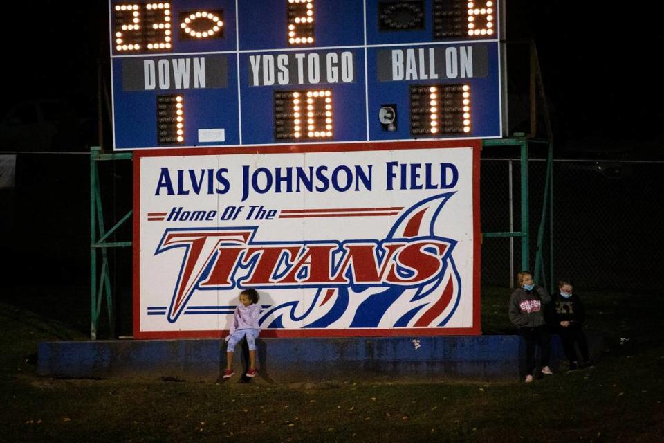 Children sit on the Alvis Johnson Field sign during a game between Mercer County and Henry County in 2020 in Harrodsburg.