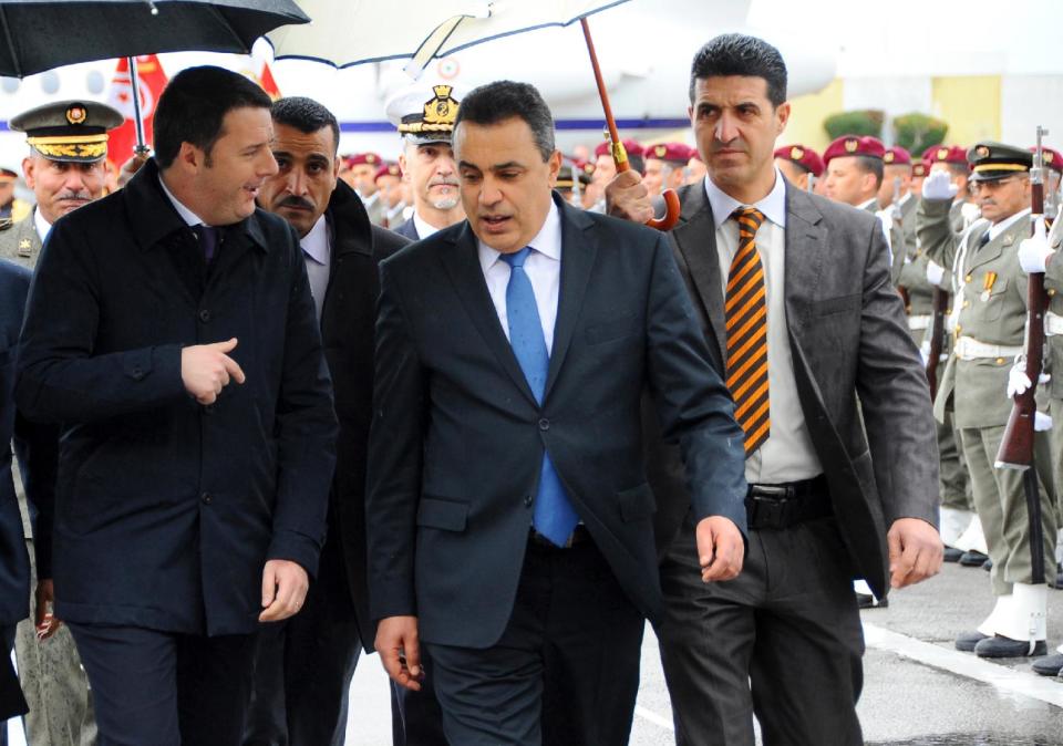 Tunisian Prime Minister, Mehdi Jomaa, 2nd right, greets his Italian counterpart, Matteo Renzi, upon his arrival at Tunis airport, Tunisia, Tuesday, March 4, 2014. Renzi is in Tunisia for a one-day official visit. (AP Photo/Hassene Dridi)