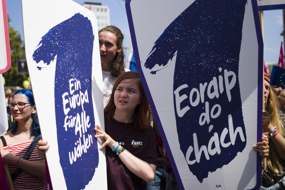 People hold posters reading: 'Elect a Europe for all' as they attend a demonstration in Berlin, Germany, Sunday, May 19, 2019. People across Europe attend demonstrations under the slogan 'A Europe for All - Your Voice Against Nationalism'. (AP Photo/Markus Schreiber)