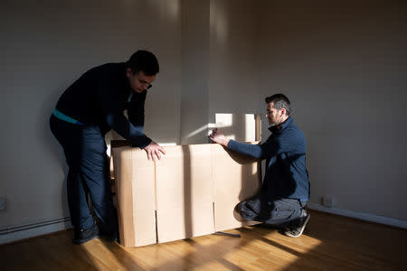 Adi (R), 37, works with his colleague Alexandru who is also from Romania, for a removal company, in London, Britain, February 14, 2019. REUTERS/Alecsandra Dragoi