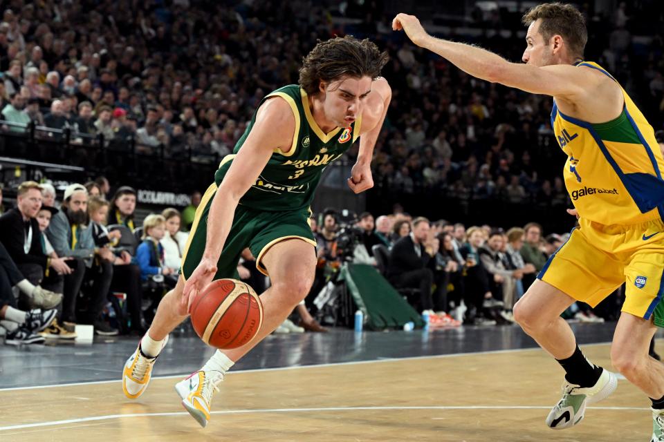 Australia’s Josh Giddey (L) drives past Brazil’s Marcelinho Huertas (R) during the international friendly basketball match between Australia and Brazil in Melbourne on August 16, 2023, in preparation for the 2023 Philippines-Japan-Indonesia FIBA Basketball World Cup. (Photo by William WEST / AFP) / –IMAGE RESTRICTED TO EDITORIAL USE – STRICTLY NO COMMERCIAL USE– (Photo by WILLIAM WEST/AFP via Getty Images)