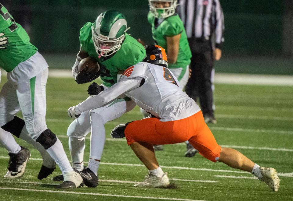 St. Mary's Asante Carter, left, is tackled by Vacaville's Justin Albrecht during a Sac-Joaquin Section Div. 2 football quarterfinal game at St. Mary's Sanguinetti Field in Stockton on Nov. 10, 2023. St. Mary's won 38-0.